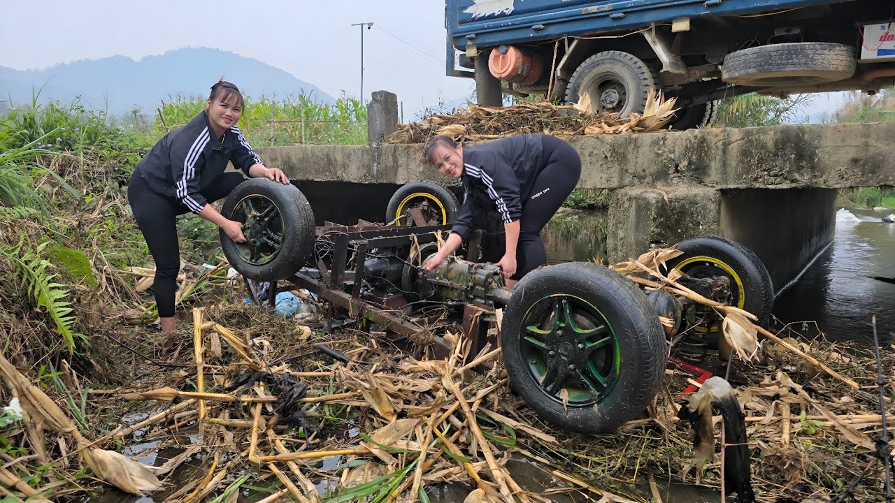 The girl repairs and restores the engine taken from a scrap car.