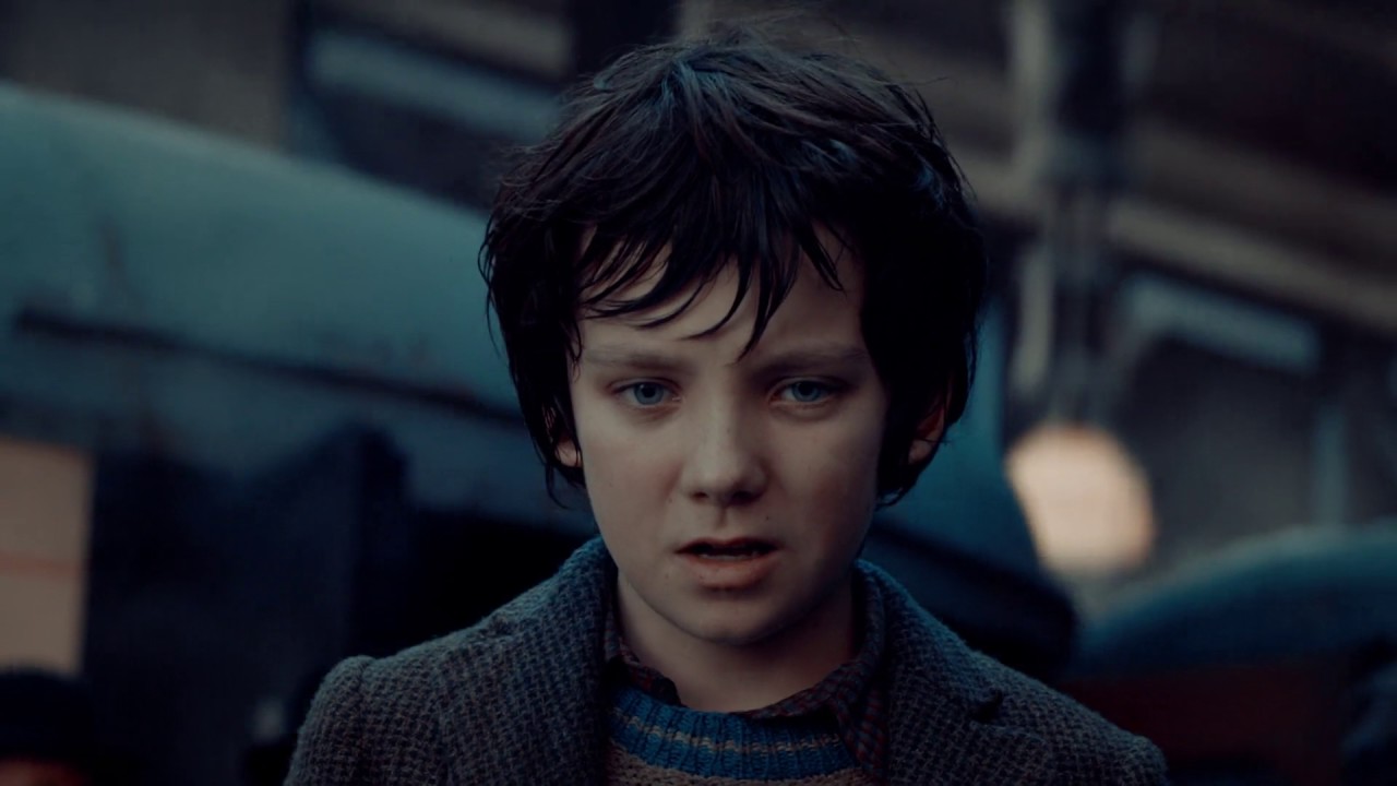 The boy who had blue eyes climbed up the clock tower, and escaped from chasing holding the robot