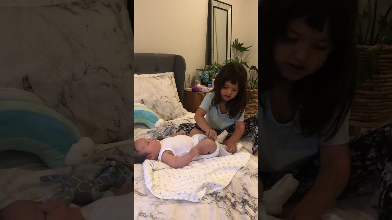 Big sister’s duty - changing nappy and dressing up baby brother