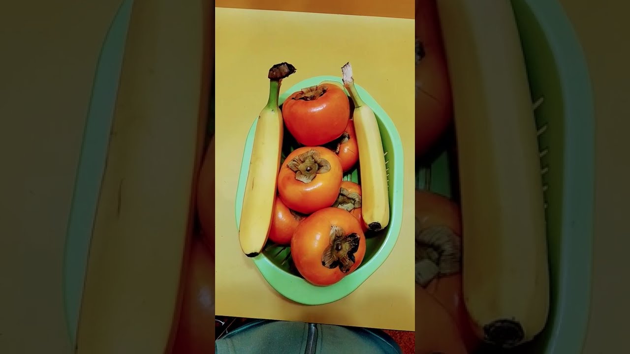 The ethylene from ripe  Bananas will help the Persimmons known as Kaki in Japan, to soften faster.