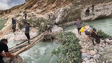 Construction of a bridge over the raging river by nomadic men
