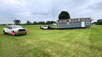 “The Amanda” our Largest Tiny Home 12’x40 Can they get it set up on this wet grass down the hill?! 😬