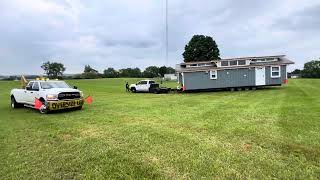 “The Amanda” our Largest Tiny Home 12’x40 Can they get it set up on this wet grass down the hill?! 😬