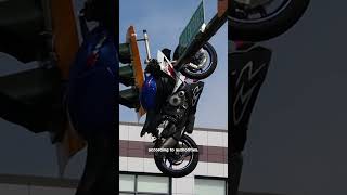 Motorcycle hanging from traffic light pole after crash