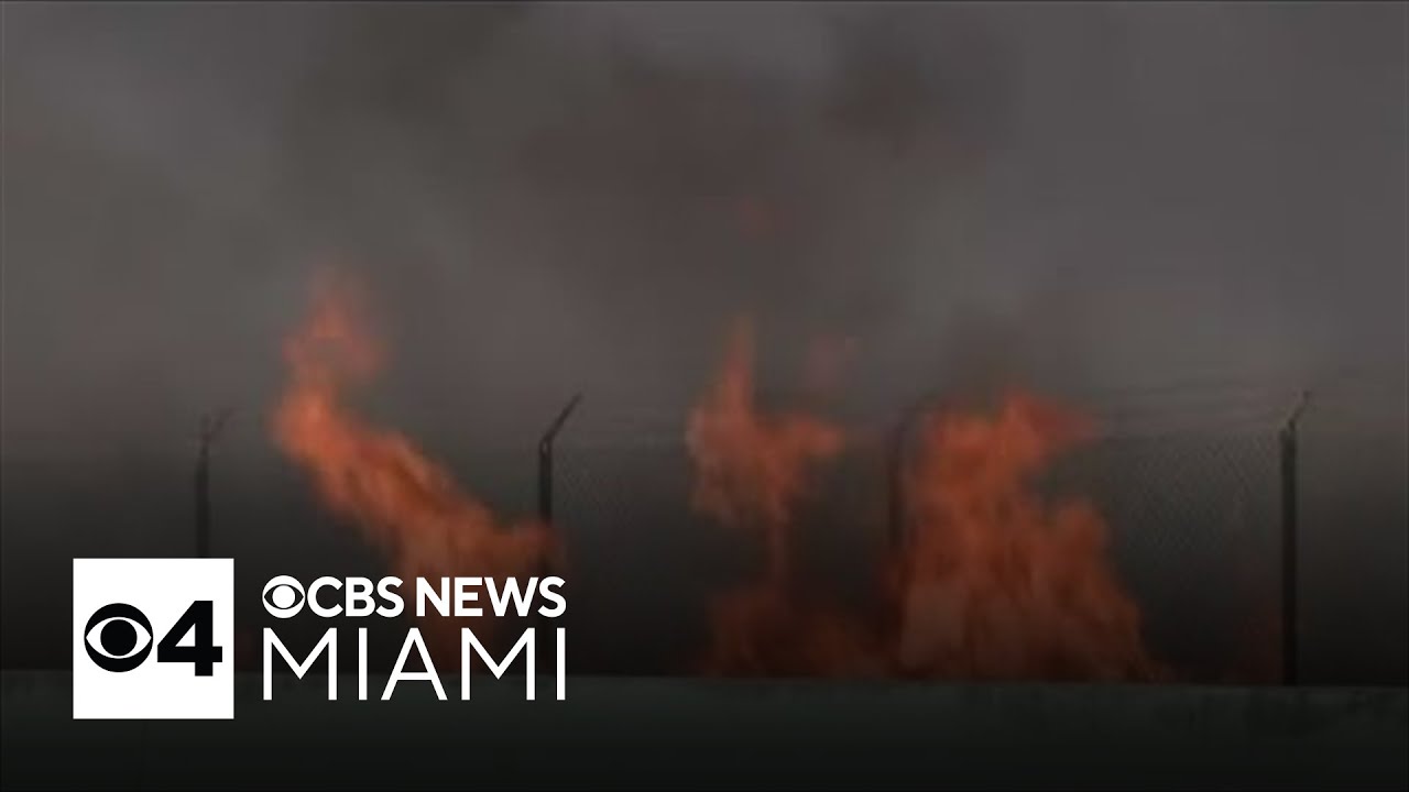 Firefighters continue to battle brush fire threatening US 1 - YouTube