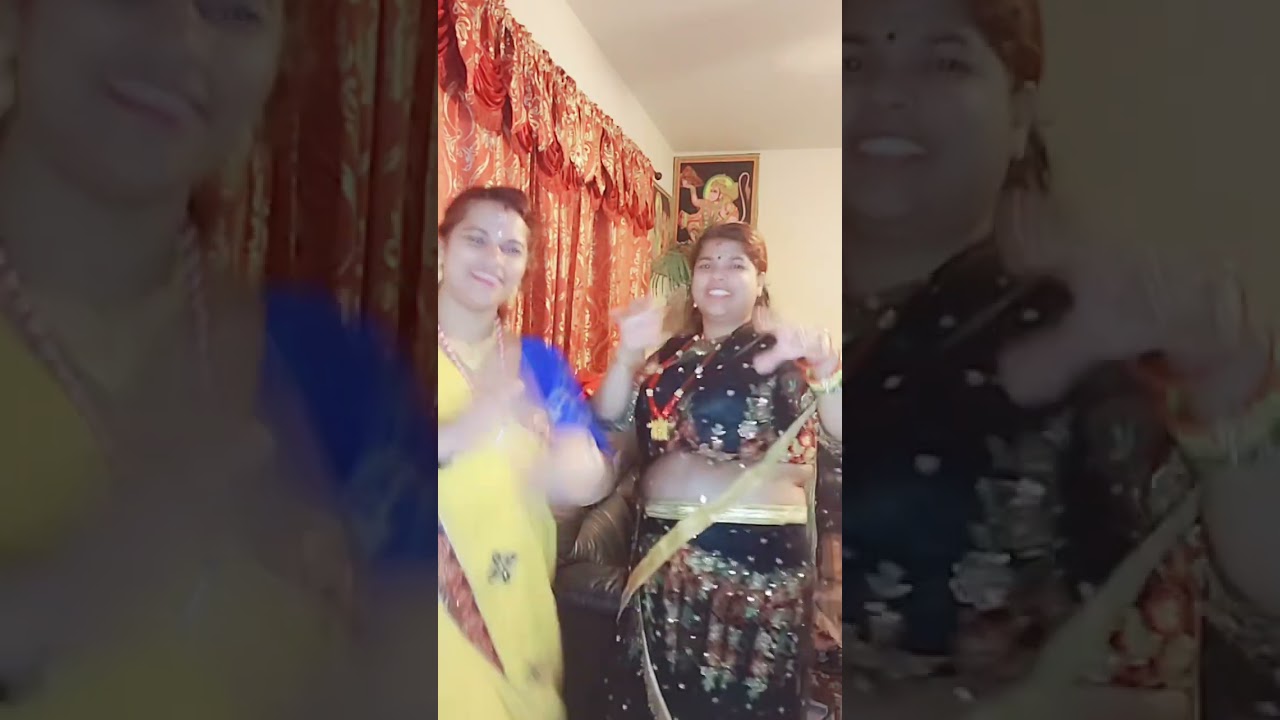 Two Women Celebrate with Dance in Saris