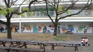 Charlottesville High School students work on huge mural