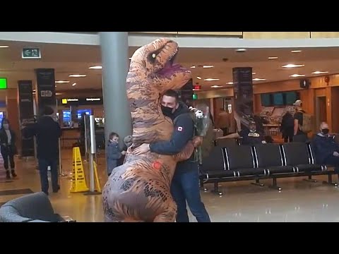 This B.C. woman wore an inflatable dinosaur costume to reunite with her partner at the airport