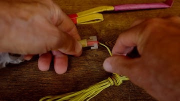 Inserting an e-match igniter into the e-match connector on a shell or cake fuse leader