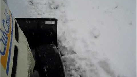 Cubcadet tractor plowing snow in snow storm