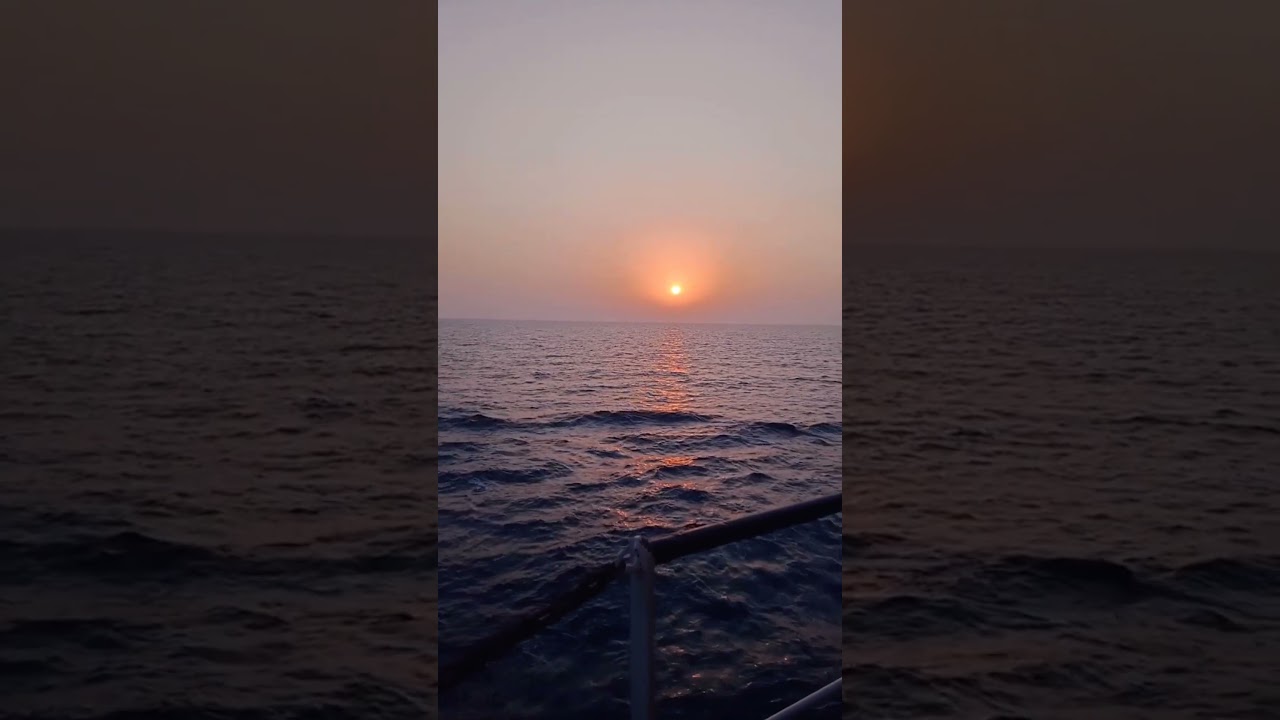 Sunset Sails: A Merchant Ship's Mesmerizing View | 