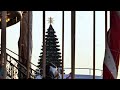 Christmas tree with star topper framed by carousel railings during holiday season
