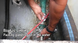 Boat is sinking. Repairing packing in the water.