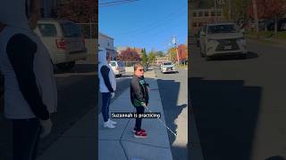 Blind students learn how to safely cross a street