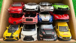 BOX full of model Cars, Rolls Royce, Tesla, Pagani, Lamborghini, RAM, DHL, Jaguar.