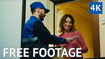 FREE 4K VIDEO - Delivery Worker Hands Parcel Over to Resident