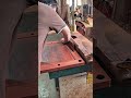 cutting slot into edge of square wooden board and smoothing it using a heavy carpentry wood jointer