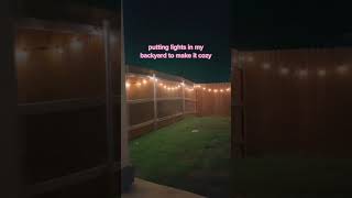 Putting string lights in my backyard to make it cozy 🤍✨