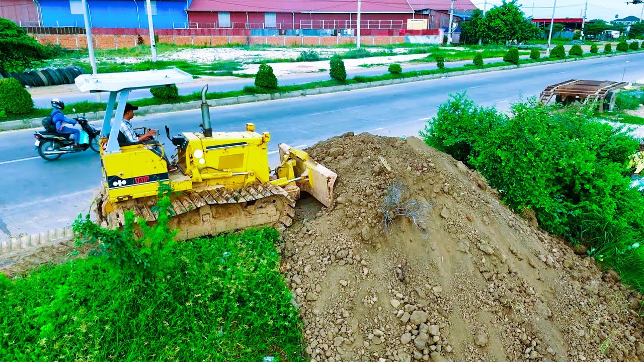 Nice full video bulldozer pushing and filling land with dump trucks