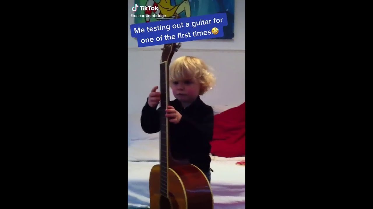 Oscar Stembridge testing out a guitar for one of the first times. - YouTube