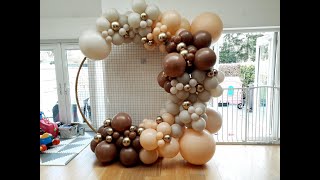 Neutral Balloon Arch on Round Gold Backdrop