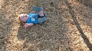 Girl lays on tire swing then little boy walks into and hits his face