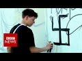 Berlin street artist group cleverly undo swastika graffiti- BBC News
