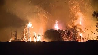 Firefighters spent another day battling 16 large wildfires around the
state that authorities say left hundreds missing and leveled entire
neighborhoods.