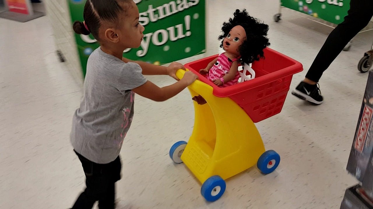 Cute Little Girl Doing Shopping At Toys 