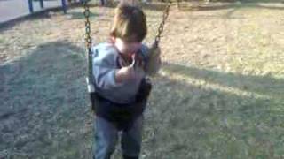 Luka on a swing with a lollipop 20100313-1612.3GP