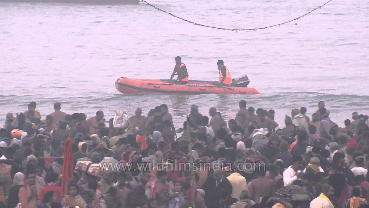 Security personnel watching over the crowd at Gangasagar mela