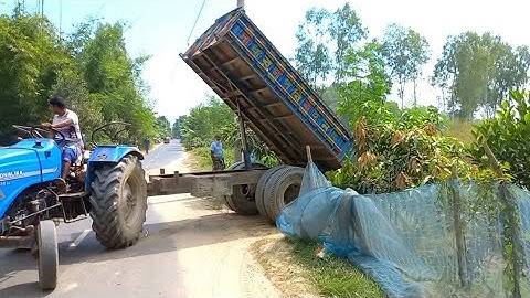Excavator loaded River Sand on Tractor Unloading by Digital Hydraulic System on Charming Roads Side