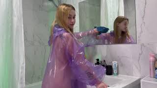 Cleaning The Bathroom In A Raincoat Wiping The Mirror And Creating A Clean Mood