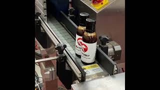 Swicyaki bottles being completed on the assembly line.