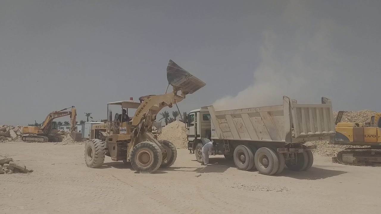 Wheel loader loading sub base in dump truck - YouTube