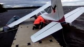 Cessna 172 Floatplane pinned to the dock in a windstorm