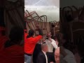 Wedding guests use chairs to keep tent from collapsing during storm #shorts