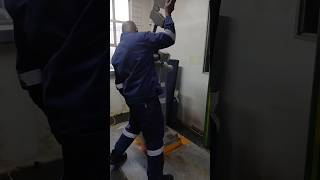 SWINGING AND DROPPING HEAVY MANUAL HAMMER ON IMPACT CHARPY TESTING MACHINE AT ROOM TEMPERATURE