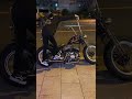 Biker girl kick starting her beautiful Harley-Davidson motorcycle