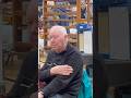 Man Scratching His Arm At Toy Fair