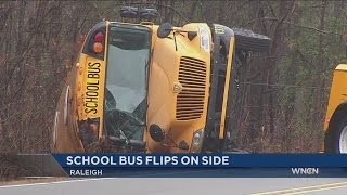 Wake Co. school bus flips going around curve in Raleigh