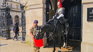 GUARD watches HORSE QUIT while his horse enjoys a DRINK and wet rub down at Horse Guards!