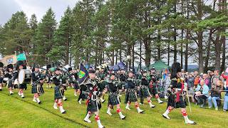 Lonach Pipe Band lead the Lonach Highlanders march during 2026 Tomintoul Highland Games in Scotland