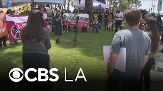 Protesters gather one year after immigration enforcement operations begin in Los Angeles County