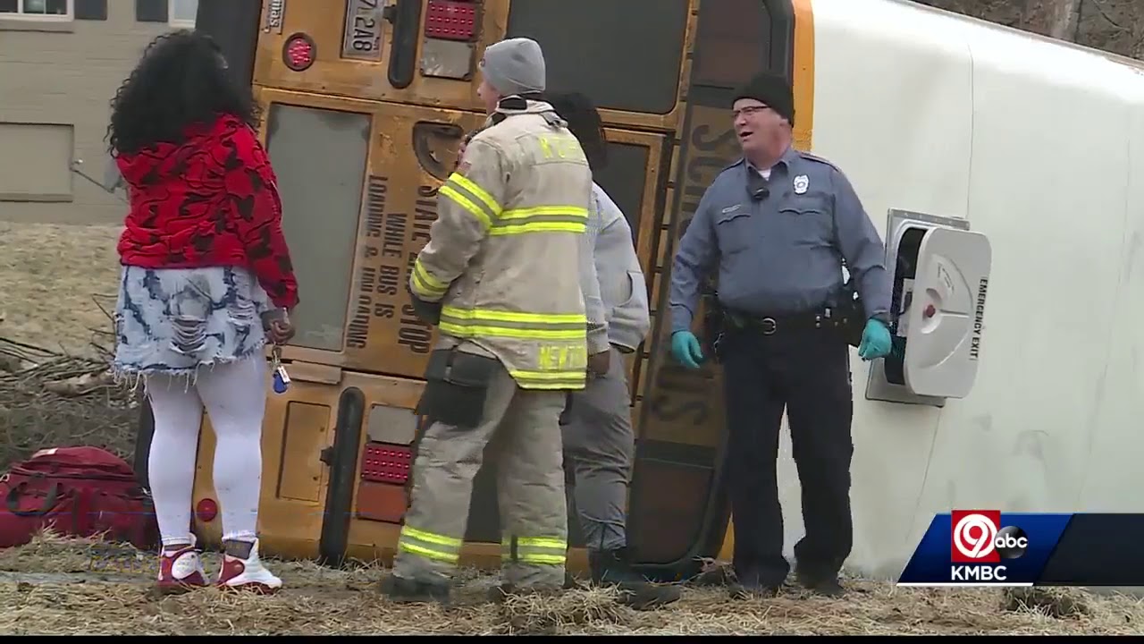 School bus hits icy patch, flips on side - YouTube