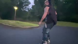 Inline skater rides around parking lot then jumps ledge and lands on wrist