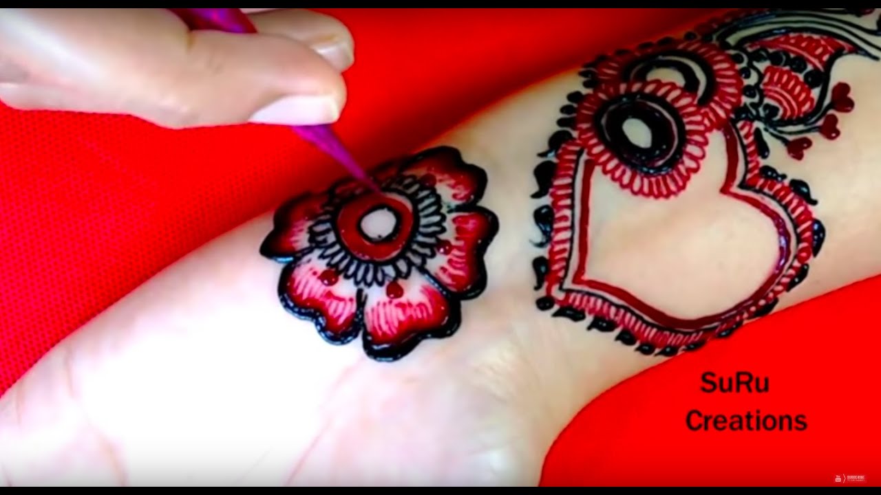 mehndi design. red colour mehndi design with two hands of girl, holi mehndi  design and pattern on woman hands Stock Photo - Alamy