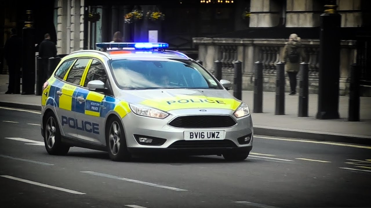 London Metropolitan Police cars responding on lights and sirens