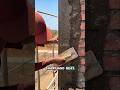 construction worker plastering the outer corner of a red brick wall.#shorts #construction #fyp