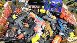 Toy Guns Box. Police Pistols, Weapons & Equipment. Box of Toy BB Guns Collection. Bomb, Bullets